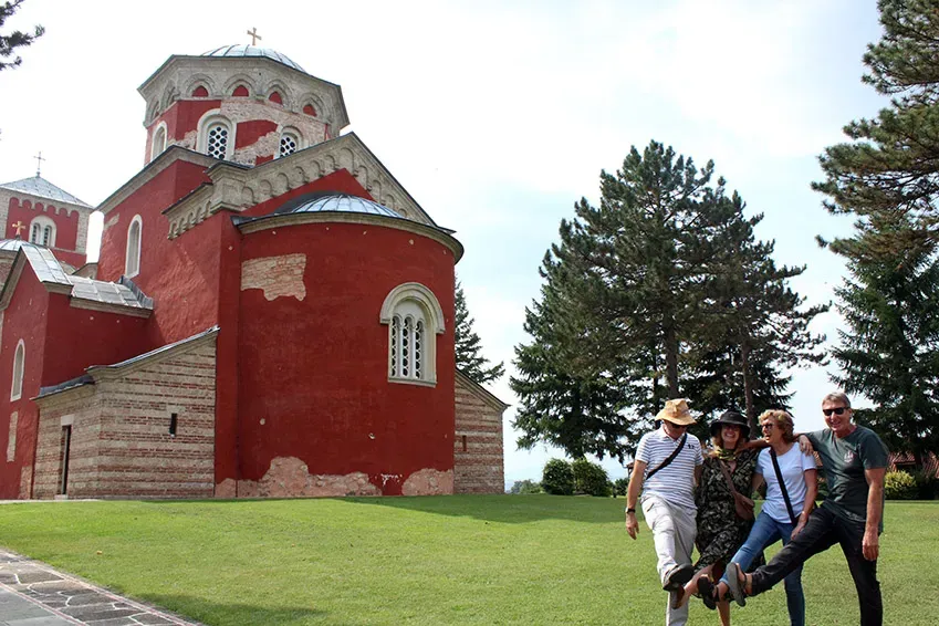 Group of four is standing in front of the monastery zica.
