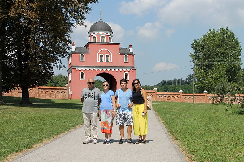 Family is posing in front of the monastery Krusedol during their Serbia holiday package.